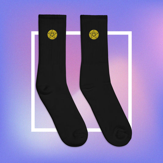 Vibrant yellow pentacle design on comfortable, high-quality black socks.